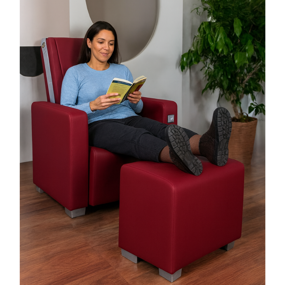 Femme avec les pieds sur le repose-pieds du fauteuil Silver Primera